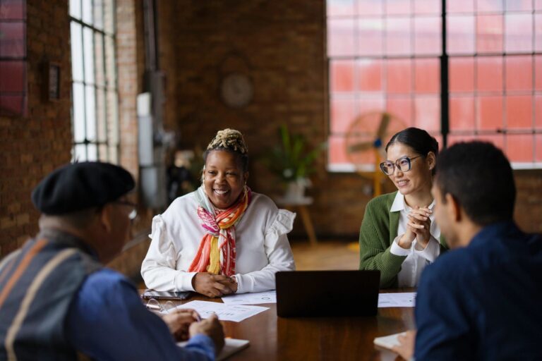 Happy diverse entrepreneurs talking on a meeting in the office.